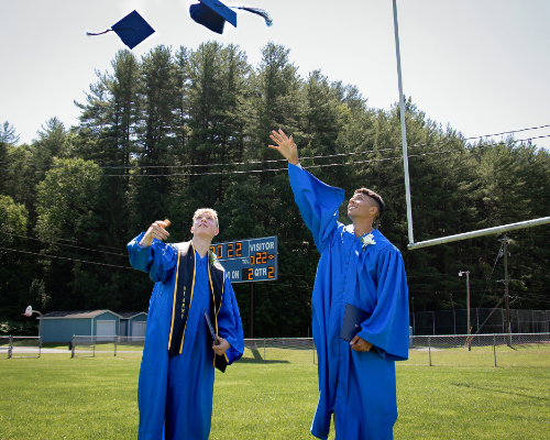 Graduates tossing caps (6/2022)