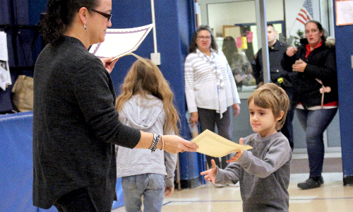 HES student receives certificate from teacher 2019