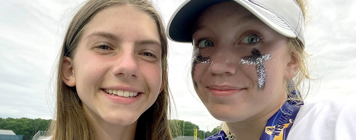 Softball players with state championship medals (6/2022)