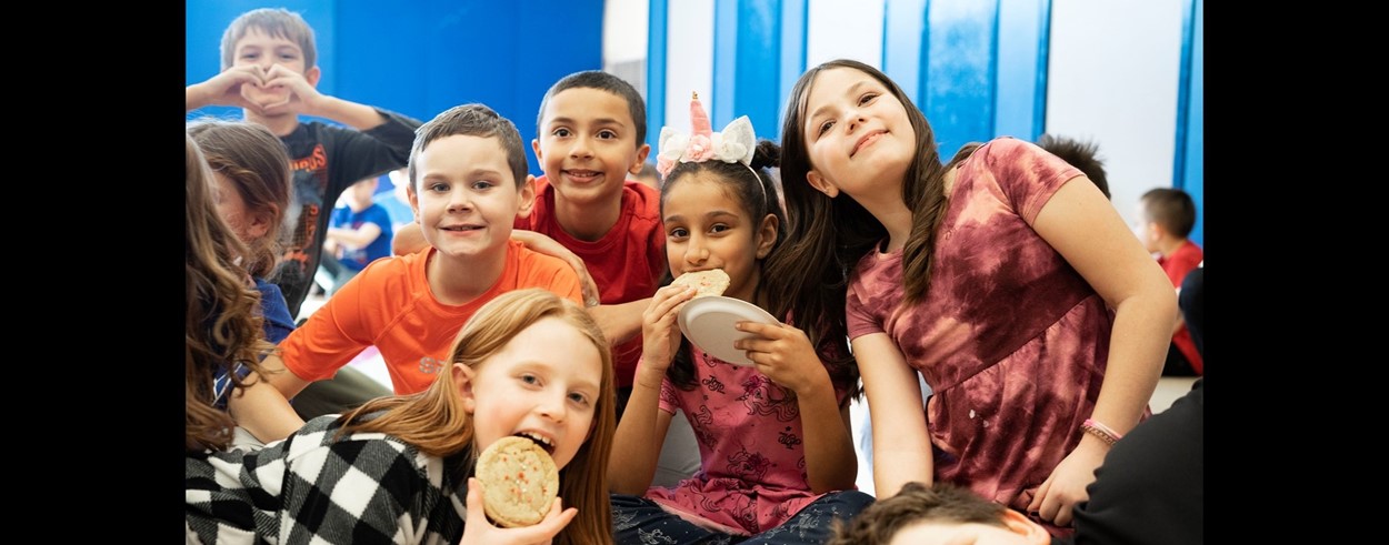 Elementary School students enjoying cookies and lemonade in group