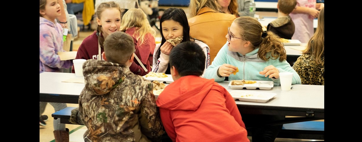 Elementary School students enjoying food during literacy night event